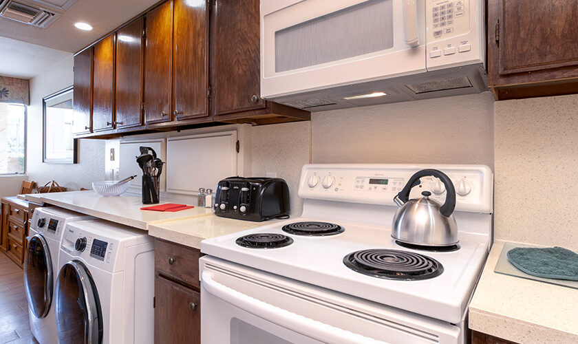 Kitchen with white stove and white washer and dryer