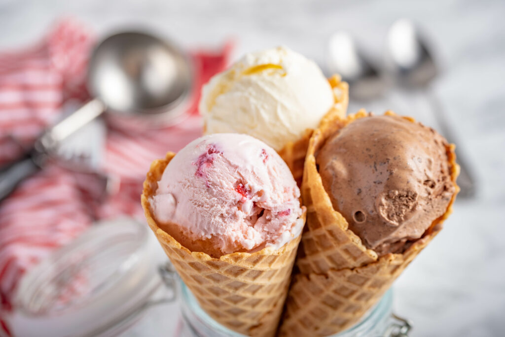 strawberry, vanilla, chocolate ice cream woth waffle cone on marble stone backgrounds